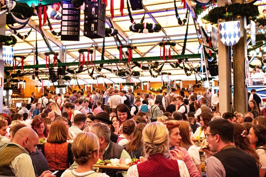 Munich: Oktoberfest Tour with Tent Reservation, Food & Beer - Entering the beer tent with a reserved table, and what changes in the party